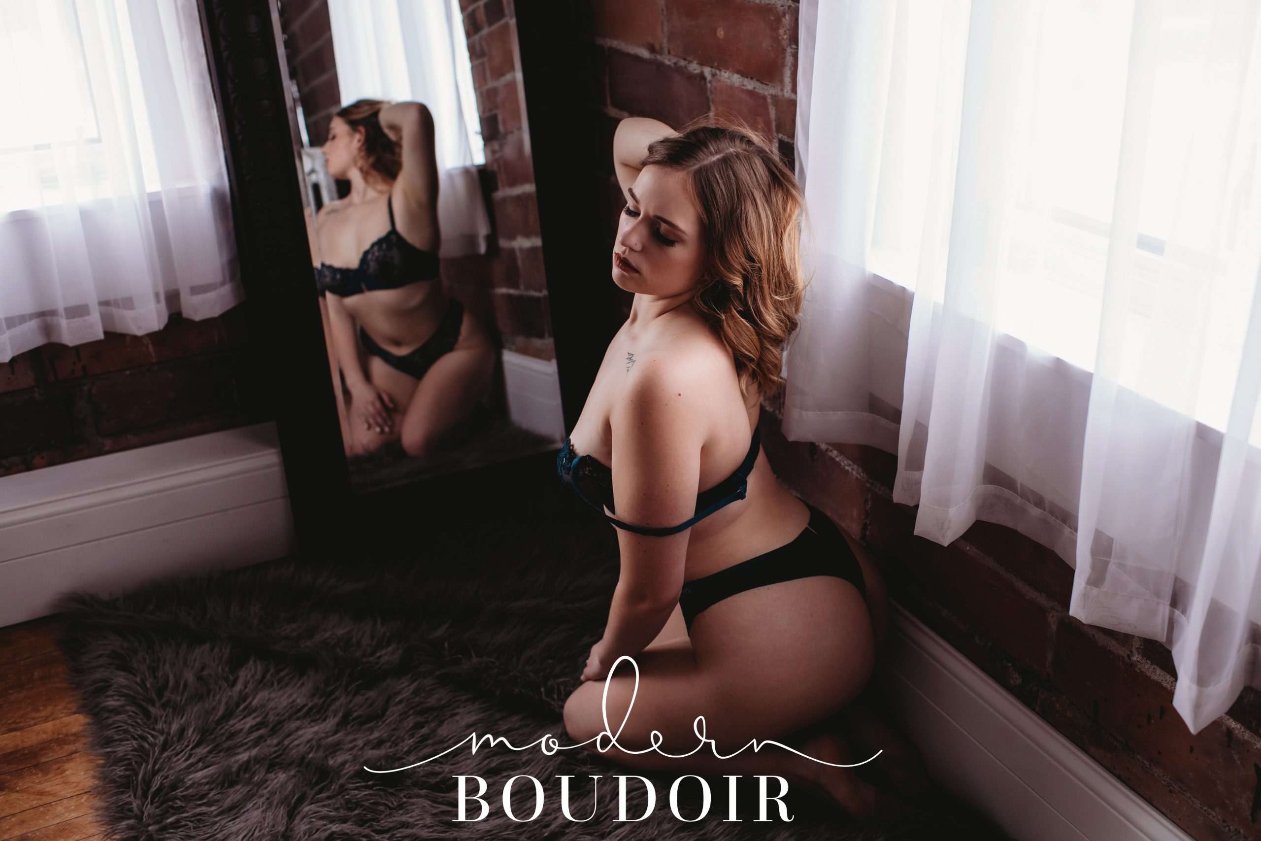 Mirror boudoir photo of woman in lingerie posing for Modern Boudoir in Boone, Iowa